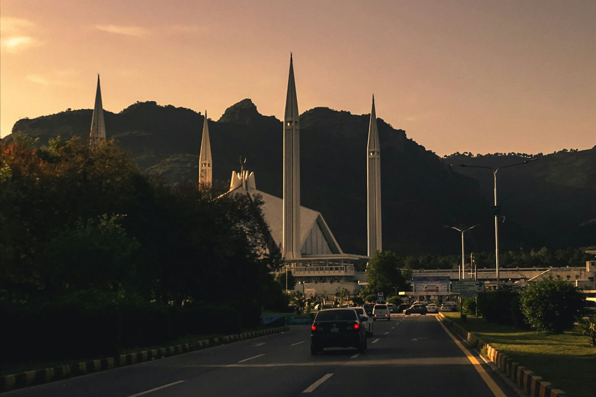 Islamabad skyline at golden hour with the Margalla Hills behind Faisal Mosque